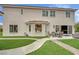 Back exterior showing a covered patio, manicured landscaping, and sliding glass doors to an immaculate home at 7211 Heggie Ave, Las Vegas, NV 89131