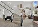 Bright foyer features high ceilings, winding staircase, and wood-look floors leading to the living room at 7211 Heggie Ave, Las Vegas, NV 89131