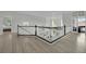 Bright foyer with a staircase, white railings, and elegant lighting, and views of the living spaces at 7211 Heggie Ave, Las Vegas, NV 89131