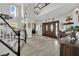 Inviting foyer with double doors, wood-look floors, staircase, and decor provides a warm welcome at 7211 Heggie Ave, Las Vegas, NV 89131