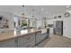 Bright kitchen with large island, stainless steel appliances, and farmhouse sink at 7211 Heggie Ave, Las Vegas, NV 89131