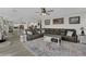 Spacious living room featuring a large sectional, open floorplan, and contemporary decor and furnishings at 7211 Heggie Ave, Las Vegas, NV 89131