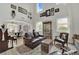 Inviting living room featuring high ceilings, wood-look floors, and multiple windows for natural light at 7211 Heggie Ave, Las Vegas, NV 89131