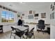Bright office area featuring built-in desks, storage cabinets, and a large window at 7211 Heggie Ave, Las Vegas, NV 89131