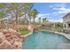 Gorgeous pool area with rock waterfall, slide, swing, and gazebo for luxurious outdoor living at 7211 Heggie Ave, Las Vegas, NV 89131