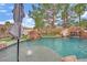 Stunning pool featuring a rock waterfall, slide, and mature trees for ultimate backyard enjoyment at 7211 Heggie Ave, Las Vegas, NV 89131