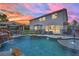 Luxurious backyard pool with waterfall feature, gazebo, lush landscaping, and secure fence at 7211 Heggie Ave, Las Vegas, NV 89131