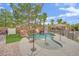Backyard pool oasis featuring rock waterfall, slide, and lush greenery, perfect for relaxation and recreation at 7211 Heggie Ave, Las Vegas, NV 89131