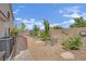 Exterior side yard with gravel landscaping, raised garden beds, and air conditioning units, for utility and gardening at 7211 Heggie Ave, Las Vegas, NV 89131