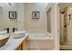 Elegant bathroom with a luxurious soaking tub and a beautifully tiled walk-in shower at 7217 Mission Hills Dr, Las Vegas, NV 89113