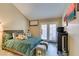 Comfortable bedroom with plush bedding and backyard access at 7217 Mission Hills Dr, Las Vegas, NV 89113