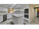 Modern kitchen features granite countertops, stainless steel appliances, and sleek cabinetry at 7217 Mission Hills Dr, Las Vegas, NV 89113