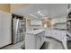 Modern kitchen featuring granite countertops, a stainless steel refrigerator, and updated cabinetry at 7217 Mission Hills Dr, Las Vegas, NV 89113