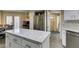 Bright kitchen featuring a granite island, stainless steel refrigerator, and ample storage at 7217 Mission Hills Dr, Las Vegas, NV 89113