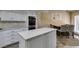 Bright kitchen with granite countertops, an island, and stainless steel appliances at 7217 Mission Hills Dr, Las Vegas, NV 89113
