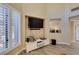 Bright living room featuring shuttered windows, a modern entertainment unit, and elegant decor at 7217 Mission Hills Dr, Las Vegas, NV 89113