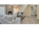 Cozy living room featuring stone fireplace, ample seating, and natural light with shuttered windows at 7217 Mission Hills Dr, Las Vegas, NV 89113
