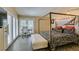 Modern main bedroom with four-poster bed, ample natural light, and work space at 7217 Mission Hills Dr, Las Vegas, NV 89113