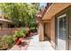 Charming backyard patio with mature landscaping and a tiled roof extension, ideal for outdoor living at 7217 Mission Hills Dr, Las Vegas, NV 89113