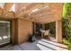 Charming outdoor patio featuring a wooden pergola, ambient lighting, and space for outdoor gatherings at 7217 Mission Hills Dr, Las Vegas, NV 89113