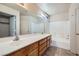 Bathroom with dual sinks, a large mirror, and a shower-tub combination at 725 Weatherstone Dr, Las Vegas, NV 89110