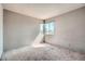 This bedroom features carpet flooring, a window for natural light, and textured walls awaiting your personal touch at 725 Weatherstone Dr, Las Vegas, NV 89110