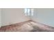 Simple bedroom with a window and neutral carpet at 725 Weatherstone Dr, Las Vegas, NV 89110