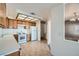 Well-lit kitchen with wood cabinetry and white appliances at 725 Weatherstone Dr, Las Vegas, NV 89110