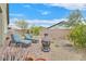 Charming backyard retreat with paved patio, desert landscaping, fire pit and comfortable lounge furniture, perfect for relaxation at 7910 Pearly Ct, North Las Vegas, NV 89084