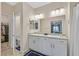 Bright bathroom featuring double sinks with granite countertops and ample storage at 7910 Pearly Ct, North Las Vegas, NV 89084