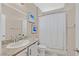 Well-lit bathroom features single sink with granite countertops and a shower with curtain at 7910 Pearly Ct, North Las Vegas, NV 89084