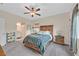 Spacious bedroom features a ceiling fan, and a window that brings in natural light at 7910 Pearly Ct, North Las Vegas, NV 89084