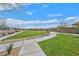 Well-maintained greenbelt featuring lush grass, mature trees, and a paved walkway, offering a peaceful outdoor space at 7910 Pearly Ct, North Las Vegas, NV 89084