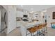 Beautiful kitchen featuring granite countertops, a large island with seating, and white cabinets at 7910 Pearly Ct, North Las Vegas, NV 89084