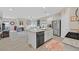 Open-concept kitchen with stainless steel appliances and an island that overlooks the living room at 7910 Pearly Ct, North Las Vegas, NV 89084