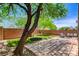 Well-kept backyard with a charming patio, green space and mature tree at 10220 Adobe Mountain St, Las Vegas, NV 89178