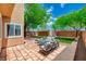 Outdoor patio with seating and a view of the well-manicured lawn and beautiful landscaping at 10220 Adobe Mountain St, Las Vegas, NV 89178