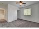 Bedroom with plush carpet, ceiling fan, closet, and window view to the outside at 10220 Adobe Mountain St, Las Vegas, NV 89178