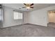 Carpeted bedroom is bathed in natural light from the window at 10220 Adobe Mountain St, Las Vegas, NV 89178