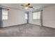 Bedroom boasts cozy carpet and ample natural light through windows with curtains at 10220 Adobe Mountain St, Las Vegas, NV 89178