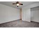 Carpeted bedroom featuring a ceiling fan, closet, and neutral decor at 10220 Adobe Mountain St, Las Vegas, NV 89178