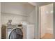 Laundry room showcases modern washer, dryer, and built-in shelving at 10220 Adobe Mountain St, Las Vegas, NV 89178