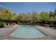 A tranquil rectangular pool surrounded by lush trees and landscaping, offering a serene escape at 10220 Adobe Mountain St, Las Vegas, NV 89178