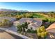 Aerial view of single Gathering home on a golf course with mountain views in the distance at 10562 Cerotto Ln, Las Vegas, NV 89135