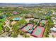Aerial view of community featuring a pool, tennis courts, green spaces, and lush landscaping at 10562 Cerotto Ln, Las Vegas, NV 89135