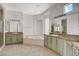 Large bathroom featuring double vanities, a soaking tub, and plenty of natural light at 10562 Cerotto Ln, Las Vegas, NV 89135