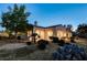 Exterior showcases lush landscaping, desert flora, a chimney, and a stucco facade at 10562 Cerotto Ln, Las Vegas, NV 89135