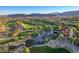 Scenic aerial view of the golf course, featuring lush greens, tranquil lakes, and beautiful community landscaping at 10562 Cerotto Ln, Las Vegas, NV 89135