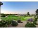 Scenic view of the golf course with lush green grass, desert landscaping, and beautiful mountain views in the background at 10562 Cerotto Ln, Las Vegas, NV 89135