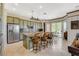 Well-equipped kitchen with stainless steel appliances, a granite island, and wood bar stools at 10562 Cerotto Ln, Las Vegas, NV 89135